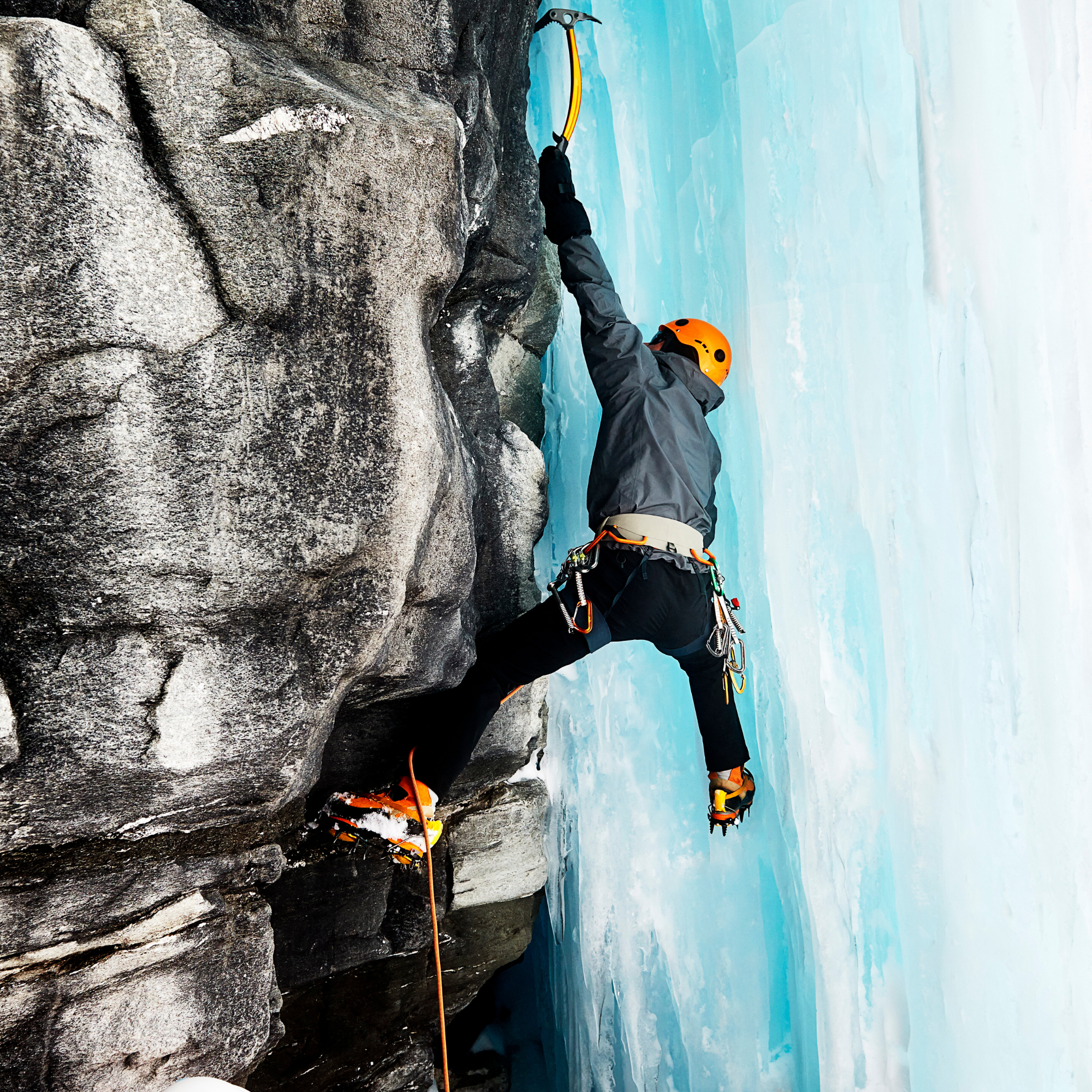 Ice climbers climbing on rock face